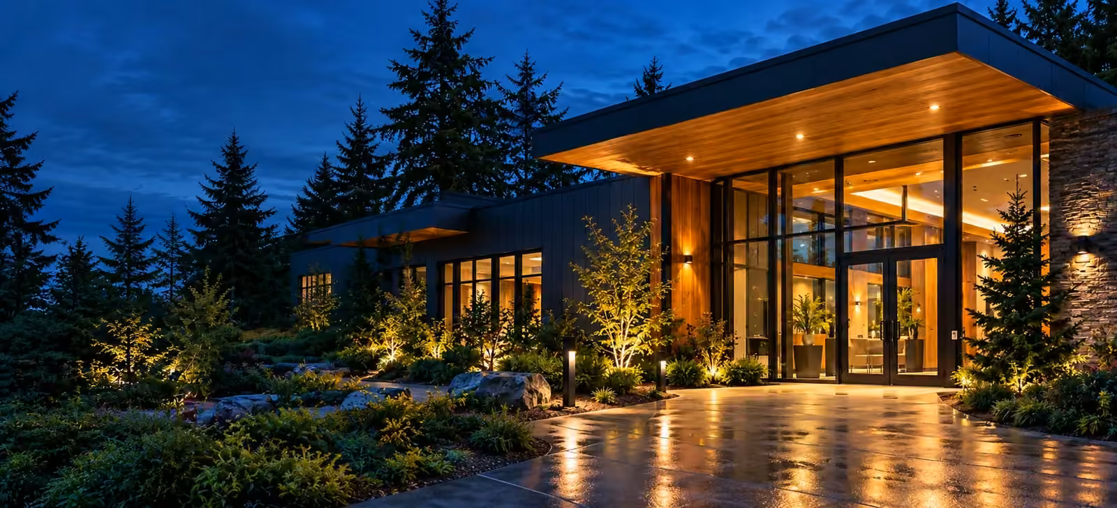 Contemporary timber and glass commercial entrance at dusk